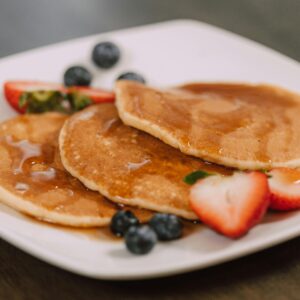 Pancakes and Fruits on a White Ceramic Plate