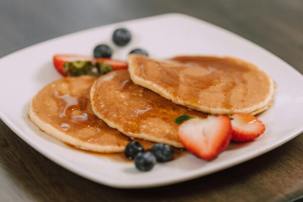 Pancakes and Fruits on a White Ceramic Plate